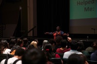 a woman giving a speech in front of an audience